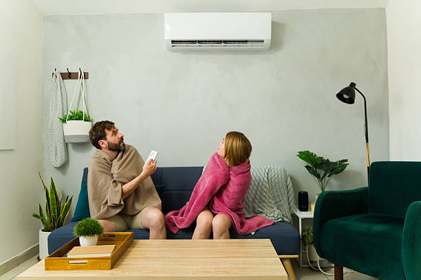 Couple freezing while using air conditioning at home and trying to change the temperature