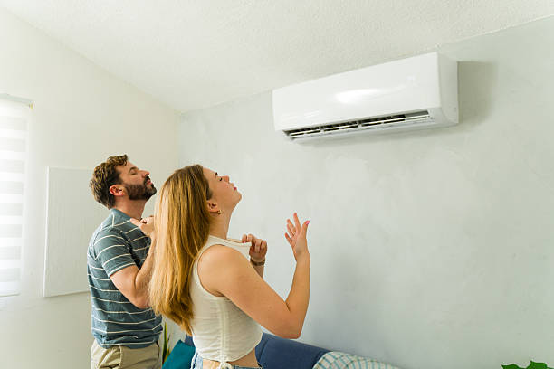 istock Couple enjoying cool air conditioning at home during summer heatwave 2209077115