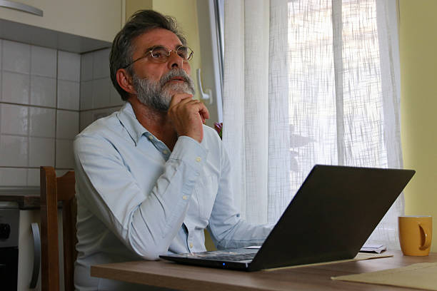 pay bill finance home senior man using technology