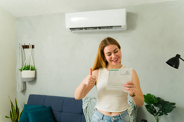 istock Happy woman saving money with efficient air conditioning unit 2209077451