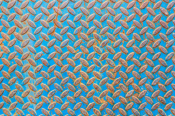 istock Close-Up of Rusty Textured Metal Plate with Blue Background 2209077731