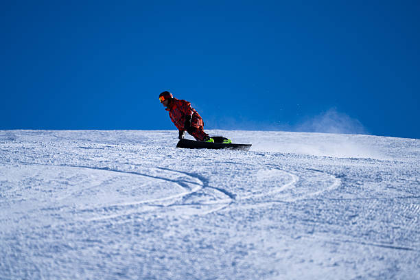 istock Snowboarder descends mountain, Swiss Alps 2209078783