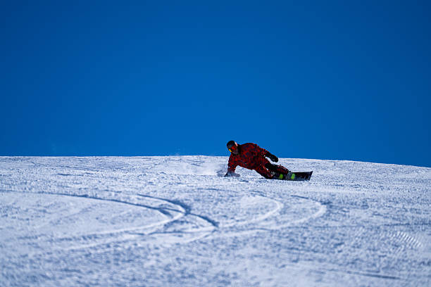 istock Snowboarder descends mountain, Swiss Alps 2209078811