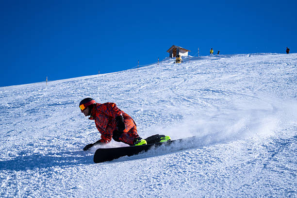 istock Snowboarder descends mountain, Swiss Alps 2209078812