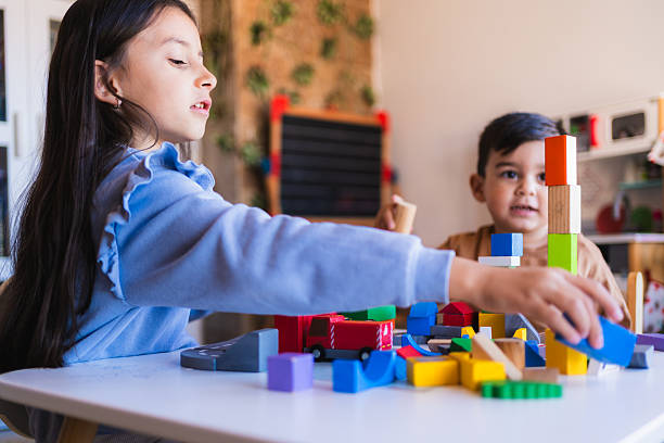 istock Brother and sister playing with building blocks at home 2209078982