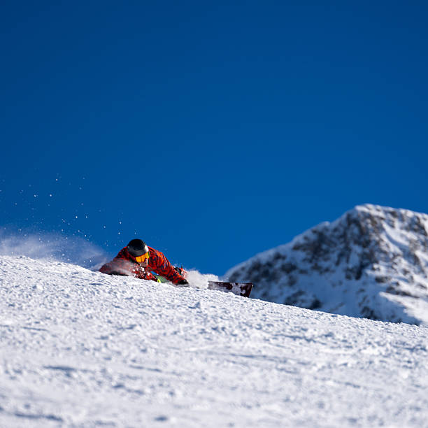 istock Snowboarder descends mountain, Swiss Alps 2209079282