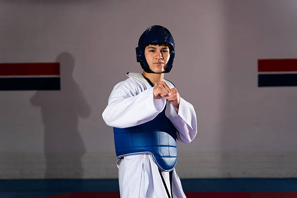 istock Young taekwondo fighter preparing for combat in training room 2209081928