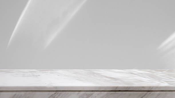 istock Marble table top with abstract shadow drop on white wall background for mockup product display 2209082276