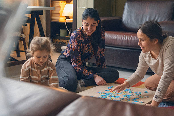 istock Family Fun Time With Child Putting Together A Puzzle 2209082577