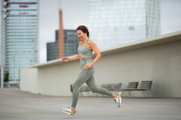istock Full body active woman running outdoors 2209083187