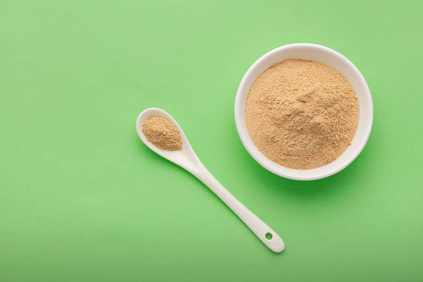 istock Peruvian maca or ginseng root in bowl and spoon  Lepidium meyenii. 2209083448