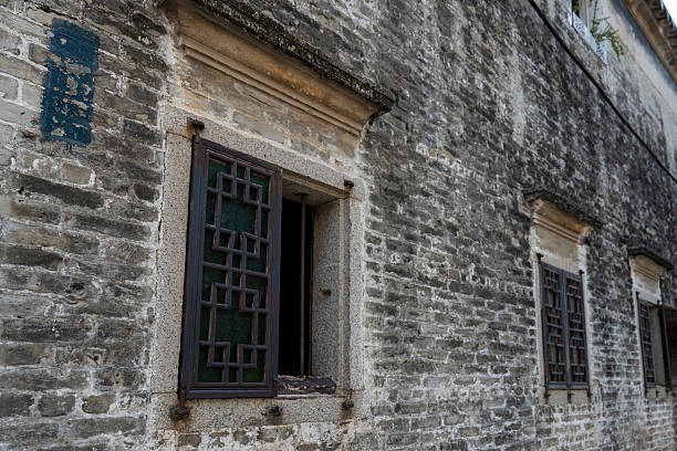 Dehang, China - April 10, 2015: Lvdongshan, unknow villages in Hunan. Old villager is looking over his fence for visitors. There are not many visitors in rural China