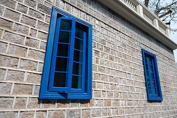 The blue checkered glass window on the stone brick wall
