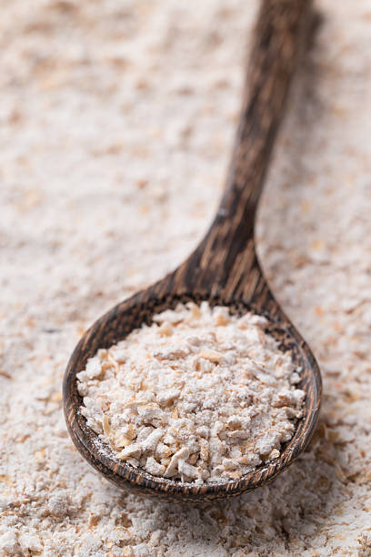 istock Whole wheat flour in spoon with flour background 2209085477