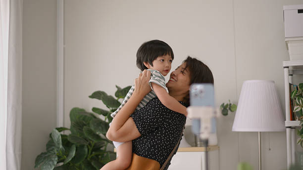 istock Asian Mother holds her child and hugs him. 2209087955