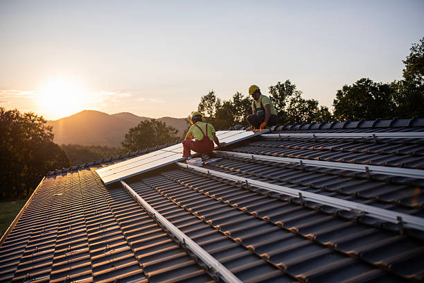 istock Workers installing solar panels on roof house in nature during sunset. 2209090641