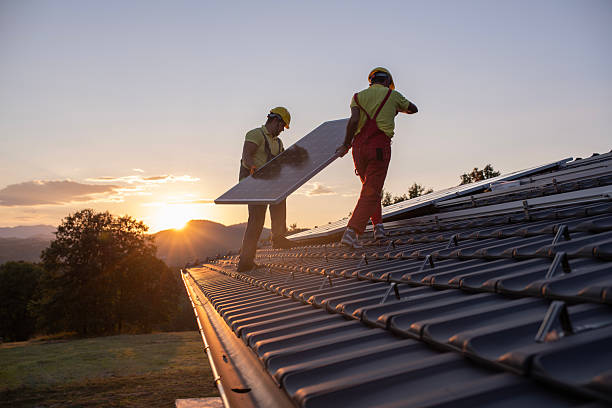 istock Blue collar workers installing solar panel system on roof house in nature at sunset light. 2209090659