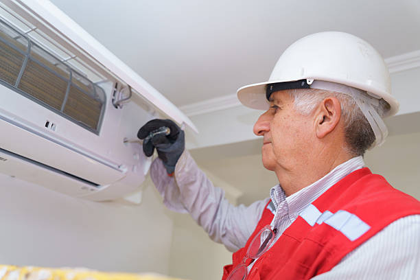 istock Senior technician repairing air conditioning unit in a house 2209098767