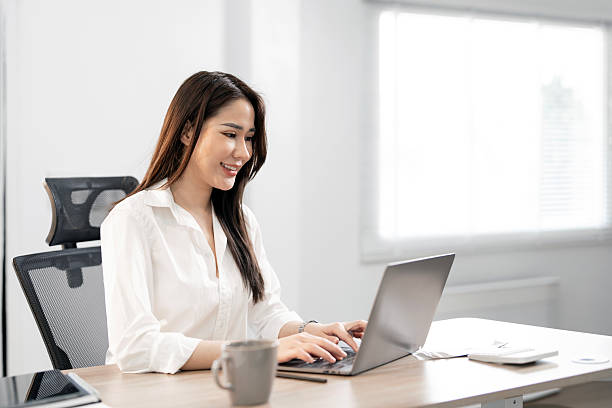 istock Young female entrepreneur working on a laptop at home 2209104011