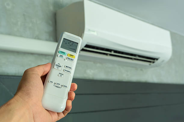 istock Man's hand using remote control open The air conditioner is cooled to 25 degrees Celsius in his bedroom. Health concepts and energy savings 2209104031