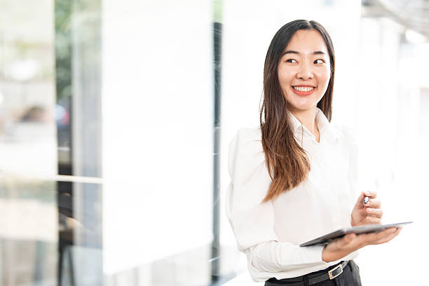 istock Successful business woman using digital tablet looking confident and smiling 2209104252