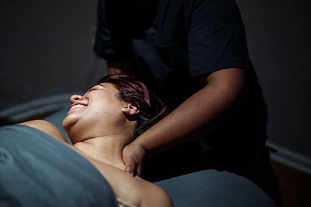 istock Smiling woman having neck and shoulders massaged 2209106162