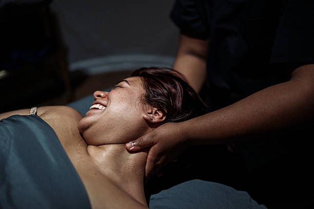 istock Smiling woman having neck and shoulders massaged 2209106175