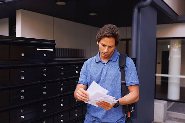 Male school teacher checking the mail after he gets home form work