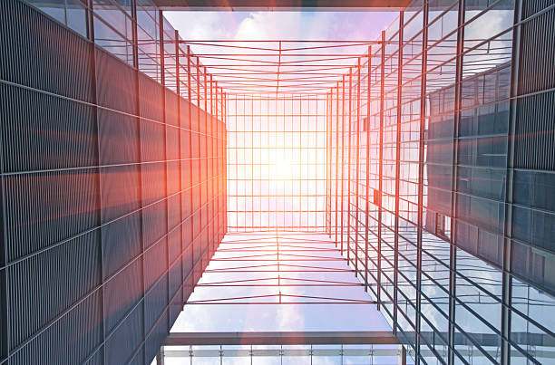 istock Modern building outer glass wall upward view in morning sunshine 2209107731