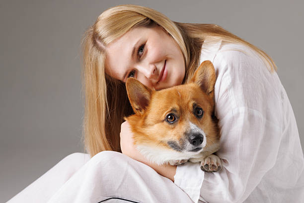 istock Young woman embraces her Corgi dog, capturing a peaceful and affectionate bond between them. 2209108581