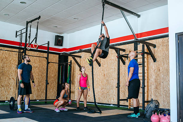 Group of athletes in the gym practicing with the rope