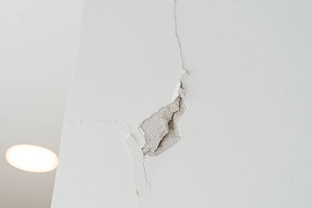 istock Cracked concrete wall broken wall after Earthquake effect. Damage building, danger and Emergency 2209111389