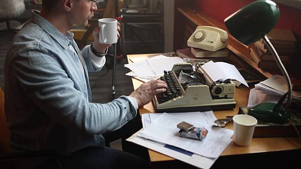 istock A male journalist smokes and writes his article intensely. 2209111588