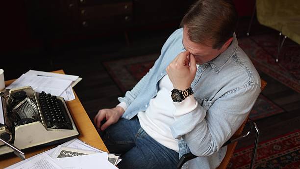 istock Writer in creative thought at vintage typewriter, cinematic soft-focus 2209111931