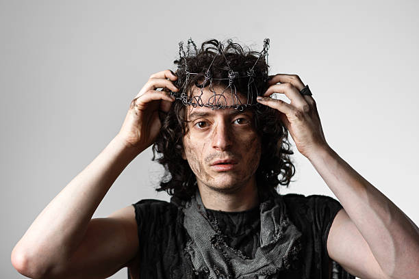 Hamlet in modern grunge or post-apocalyptic reinterpretation, young man, tragic Shakespearean hero in a crown of wire