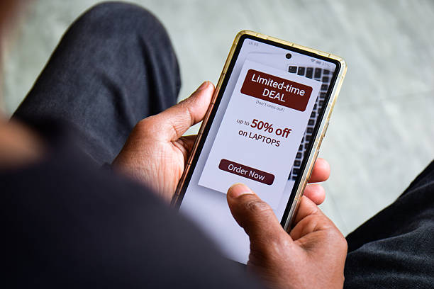 FOMO Marketing customer engagement concept on mobile screen. Man looking at a limited time deal offer and discount on his desired item. Selective focus.