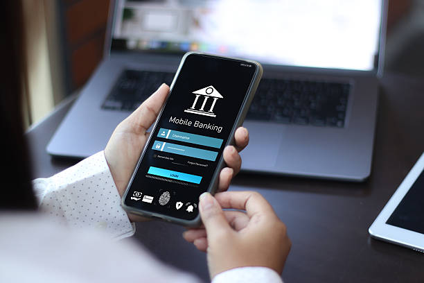istock Mobile banking technology, Cyber security.  Businessman using smartphone to do online mobile banking, Digital financial innovation technology, Investing in stocks and mutual funds for retirement. 2209113568