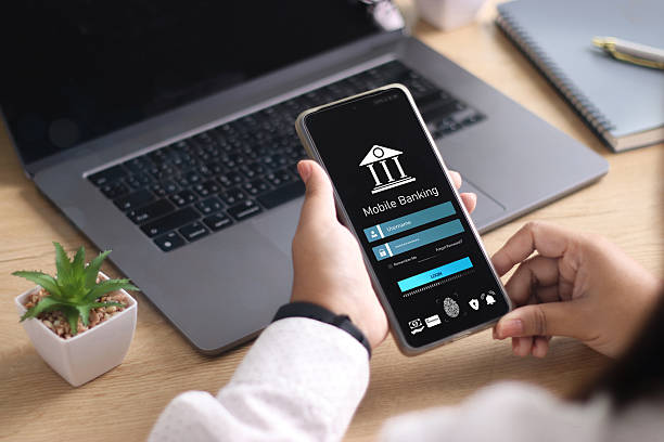 istock Mobile banking technology, Cyber security.  Businessman using smartphone to do online mobile banking, Digital financial innovation technology, Investing in stocks and mutual funds for retirement. 2209113588