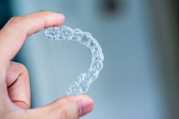 istock clear aligners device in the mouth on a white background. (invisalign) 2209115649