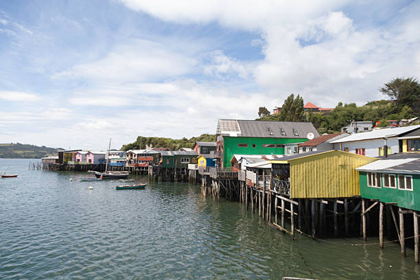 Colorful Palafito stilt houses on Chiloé Island showcase Chilote ingenuity, blending indigenous and European styles. Built over water, they embody maritime culture and harmony with the sea.