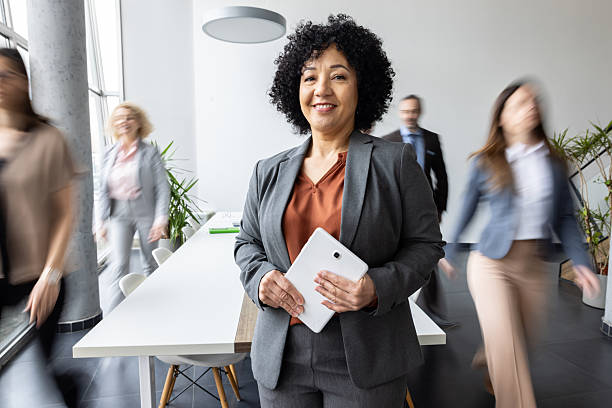 istock Confident professional smiling with tablet in office space 2209117056