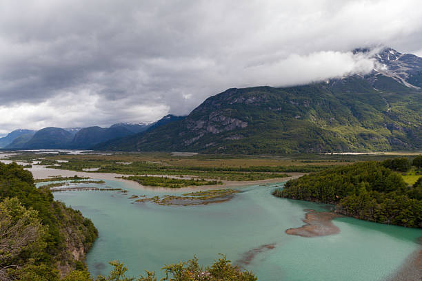 Breathtaking Chilean Patagonia: azure lakes, verdant forests, and majestic mountains. This serene scene captures Patagonia's untamed beauty, ideal for adventure and nature themes.
