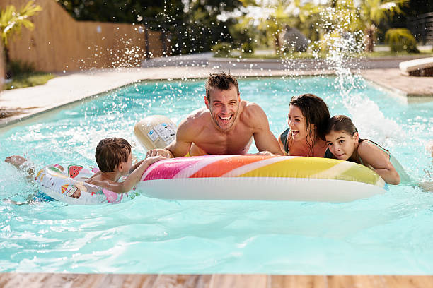 istock Cheerful family having fun during summer day in the pool. 2209122146