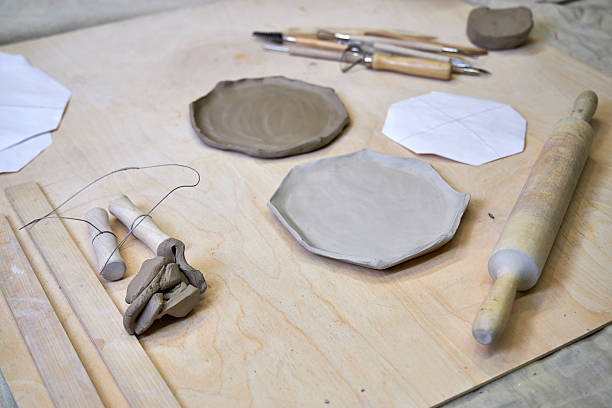 istock on a wooden table there is a blank for a handmade clay plate and tools for clay processing 2209122687
