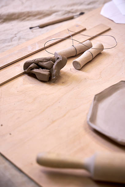 istock on a wooden table there is a blank for a handmade clay plate and tools for clay processing 2209122728