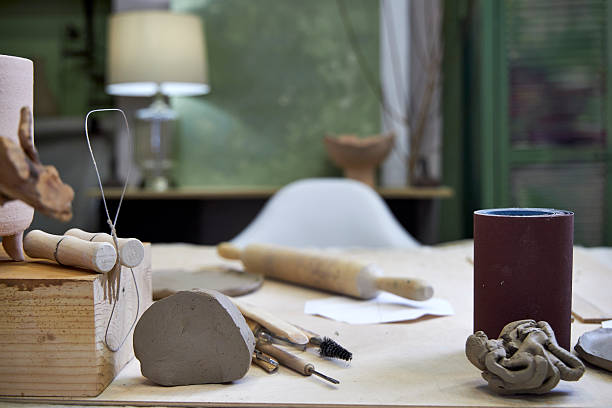 istock workshop table with pottery tools against green wall with lamp, home office concept 2209122761