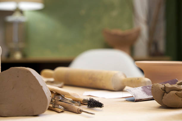 istock workshop table with pottery tools against green wall with lamp, home office concept 2209122792