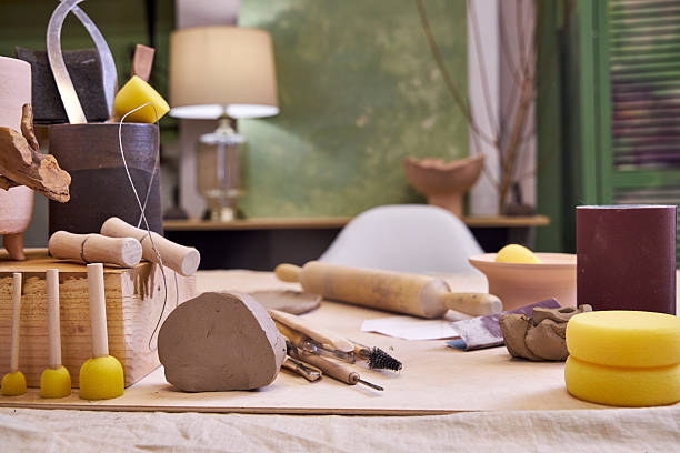 istock workshop table with pottery tools against green wall with lamp, home office concept 2209122801