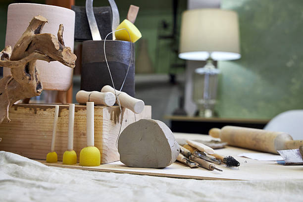 istock workshop table with pottery tools against green wall with lamp, home office concept 2209122813