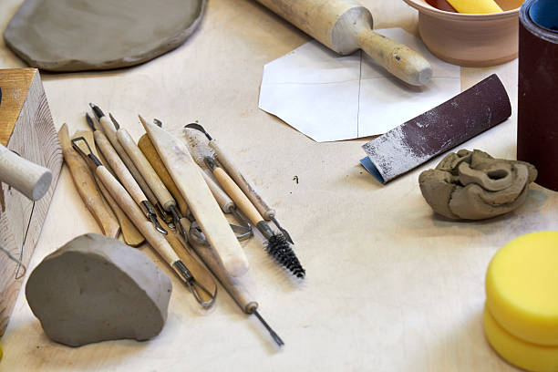 istock view of a wooden table in the workshop with pottery tools and clay, view from above 2209122819